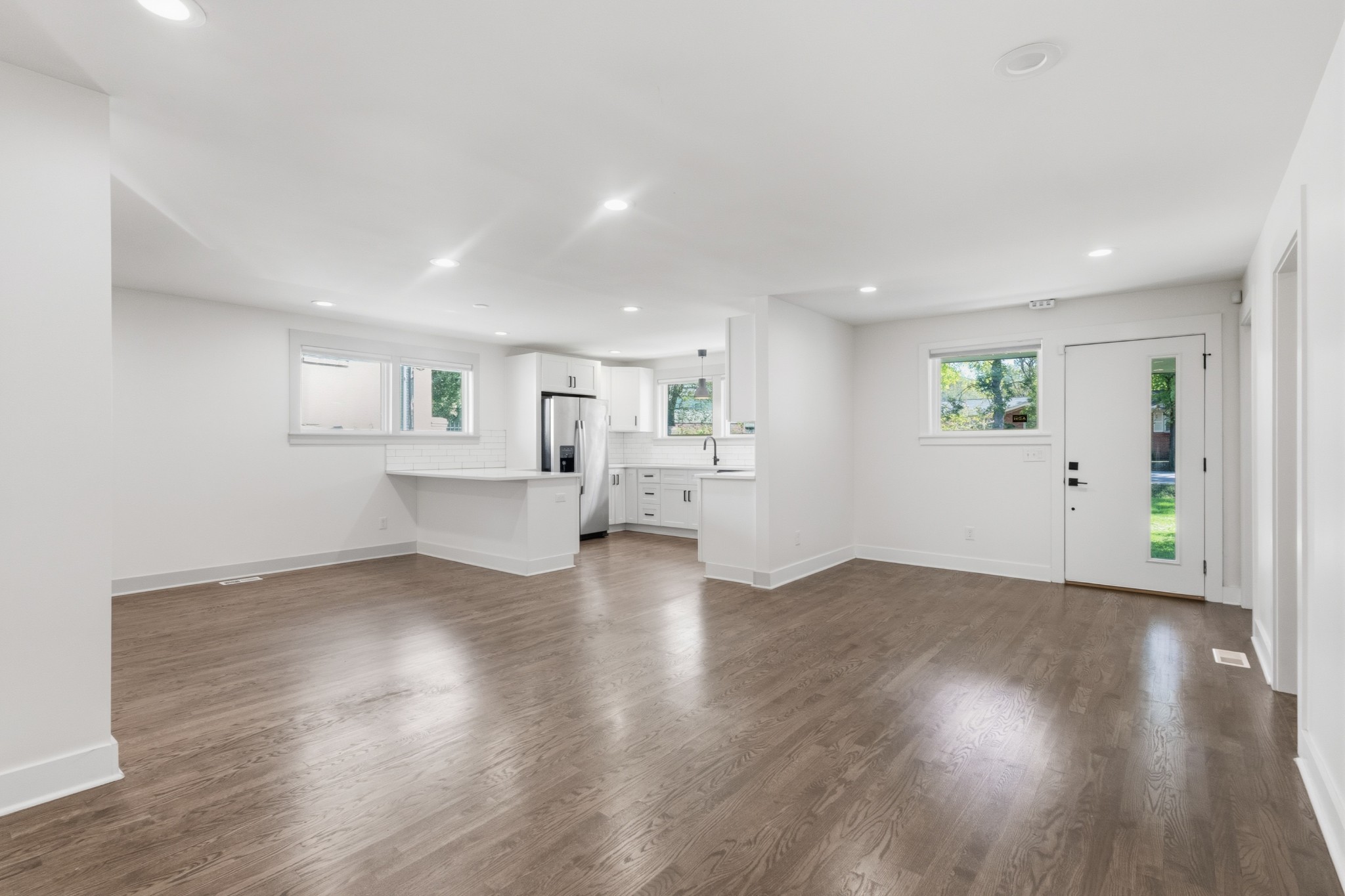652 Moormans Arm Road Nashville, TN 37207 - Photo 6 of 25 a view of an empty room with wooden floor and a window