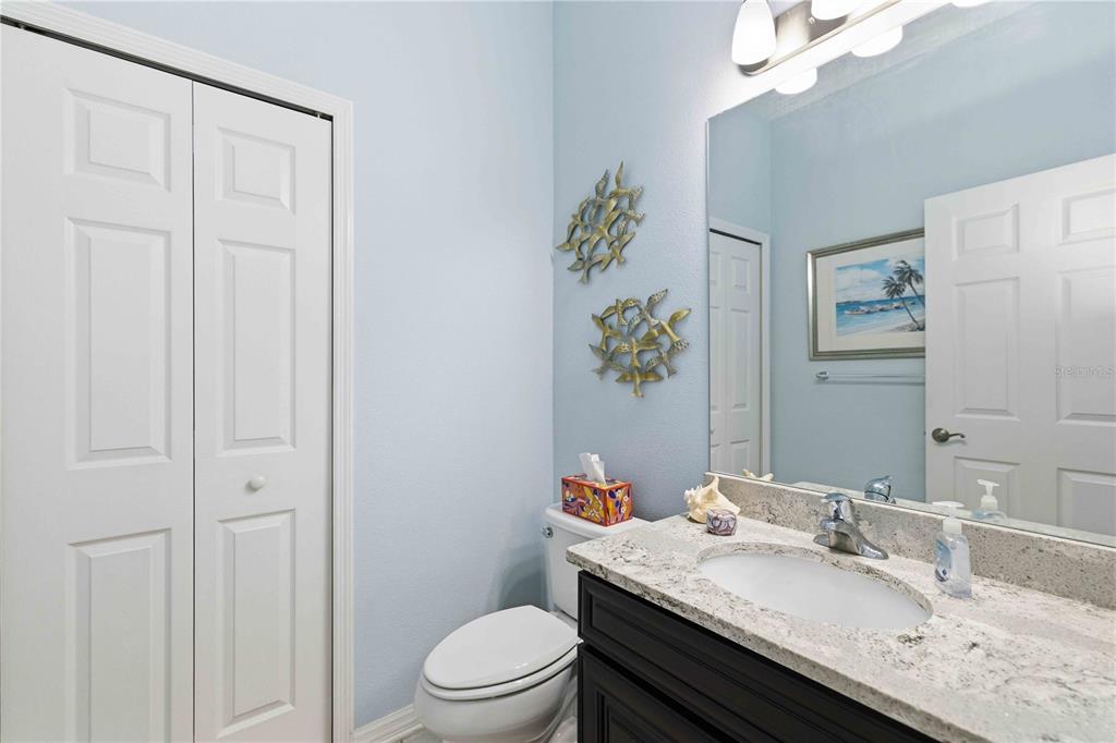 10920 79th Street East Parrish, FL 34219 - Photo 31 of 73 a bathroom with a granite countertop sink a toilet and a mirror