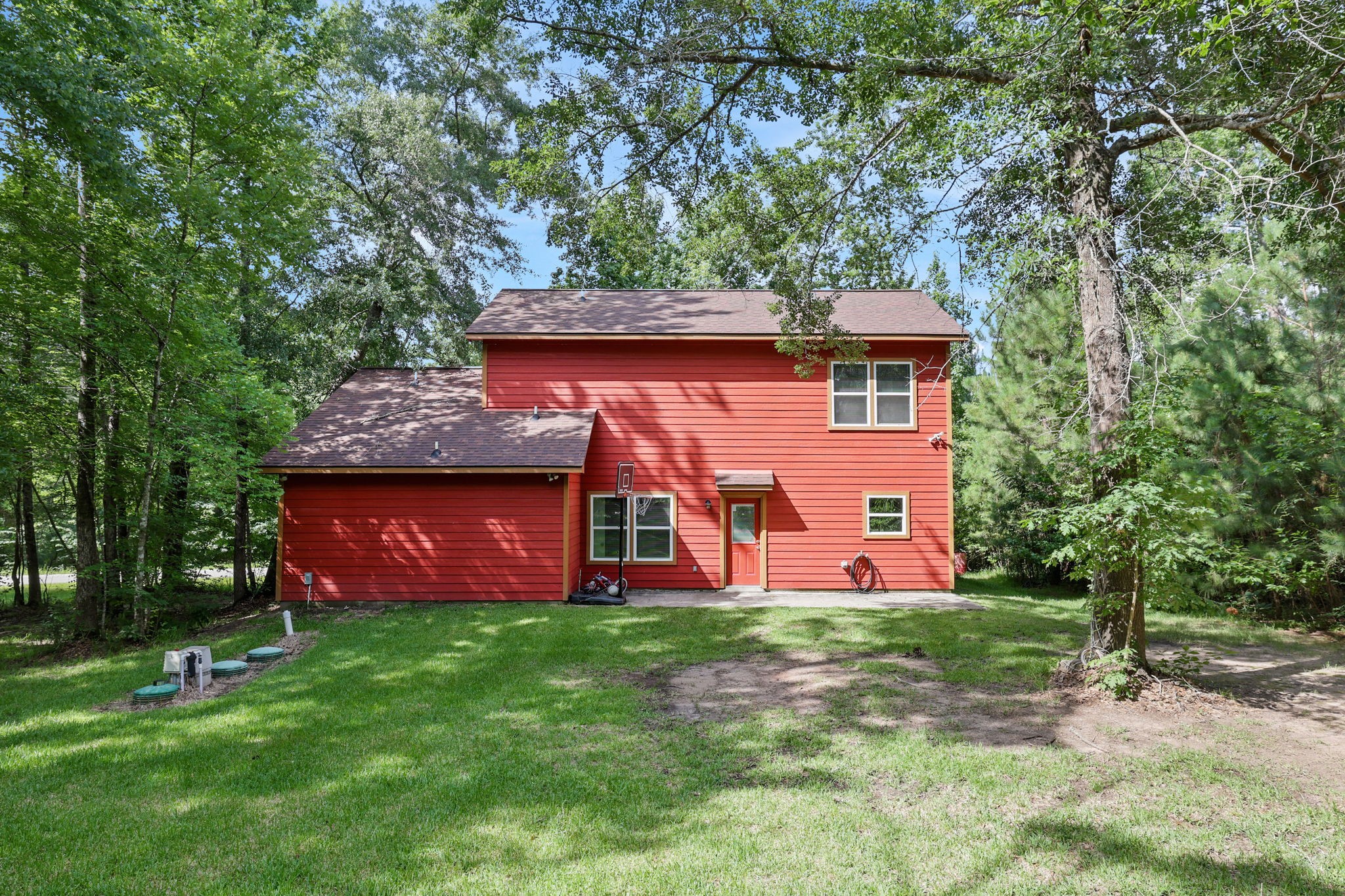 97 Harrell Road Coldspring, TX 77331 - Photo 25 of 31 Nestled among mature trees, the rear of the home offers a peaceful setting with privacy and natural beauty