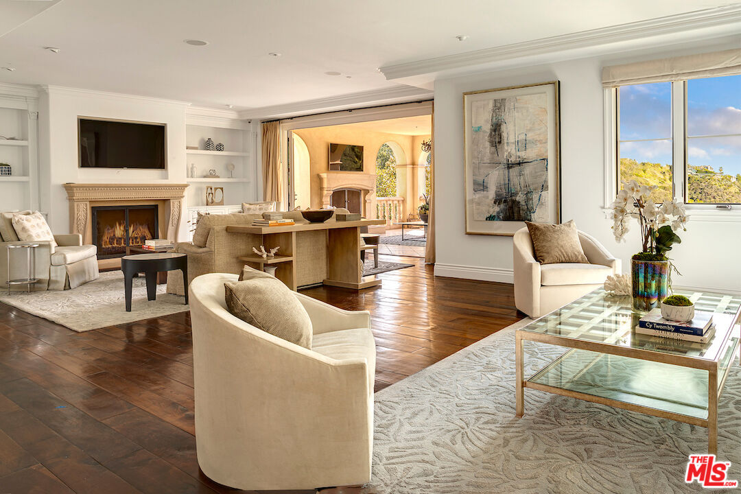 11025 Anzio Road Los Angeles, CA 90077 - Photo 12 of 34 a living room with fireplace furniture and a flat screen tv