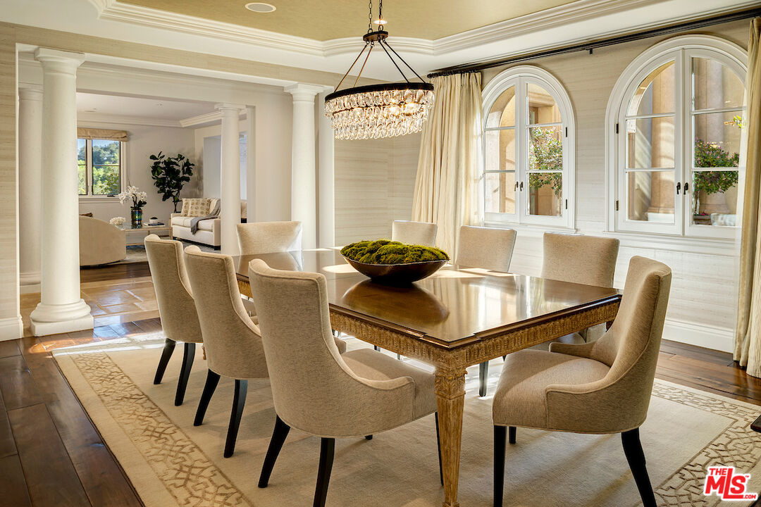 11025 Anzio Road Los Angeles, CA 90077 - Photo 14 of 34 a dining room with furniture a chandelier and wooden floor