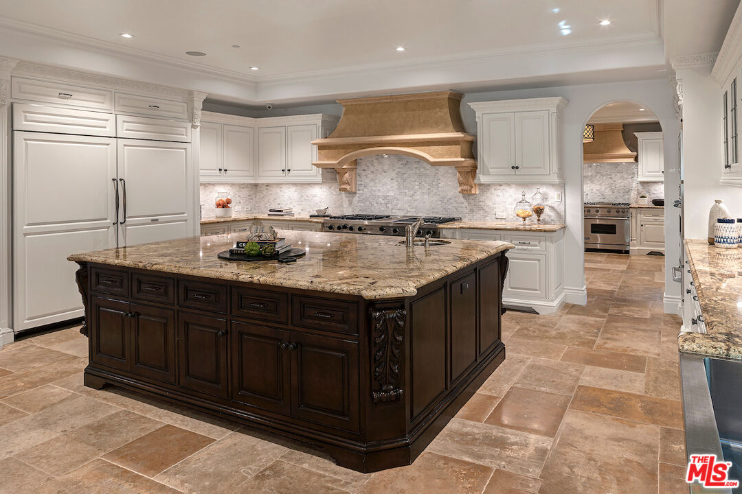11025 Anzio Road Los Angeles, CA 90077 - Photo 16 of 34 a kitchen with stainless steel appliances granite countertop a stove a sink and a refrigerator