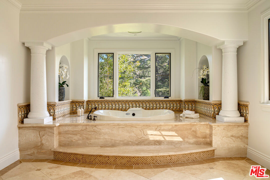 11025 Anzio Road Los Angeles, CA 90077 - Photo 24 of 34 a bathroom with bathtub with window