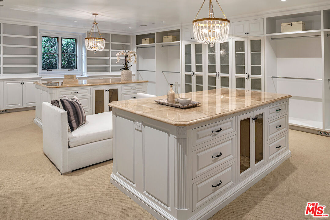 11025 Anzio Road Los Angeles, CA 90077 - Photo 26 of 34 a view of cabinets a center island a window wooden floor and a fireplace