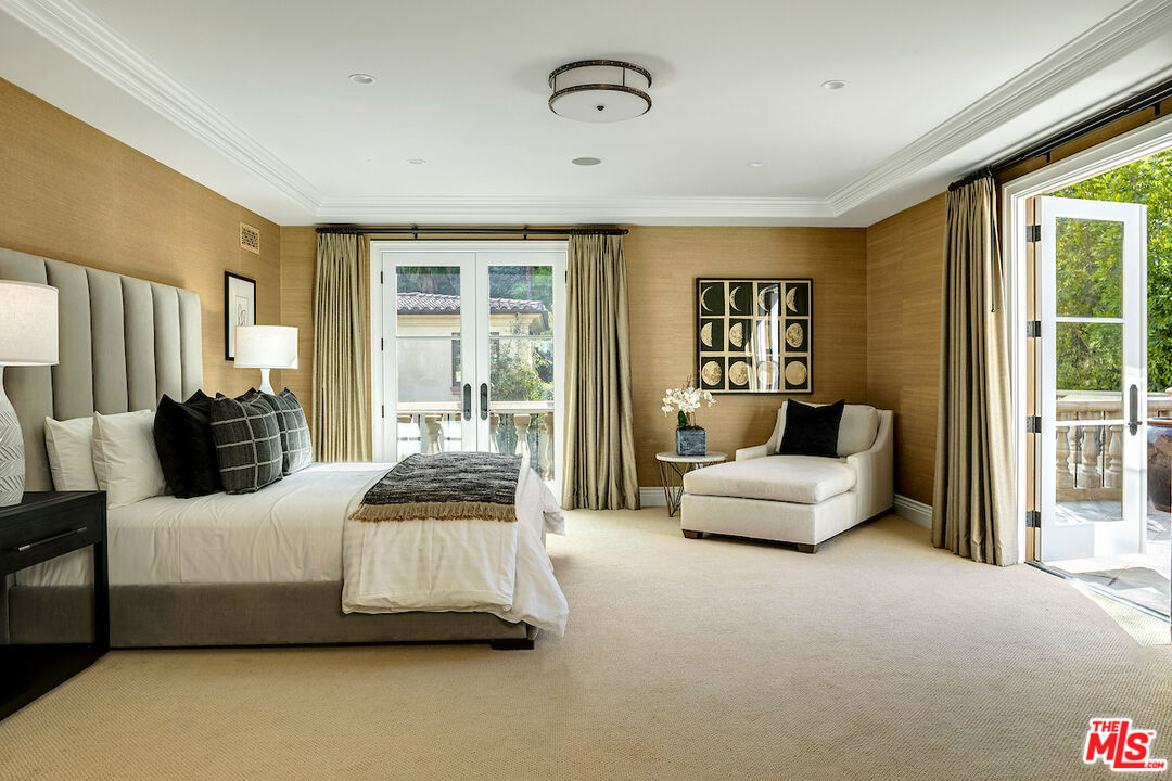 11025 Anzio Road Los Angeles, CA 90077 - Photo 28 of 34 a bedroom with a bed couch and large window