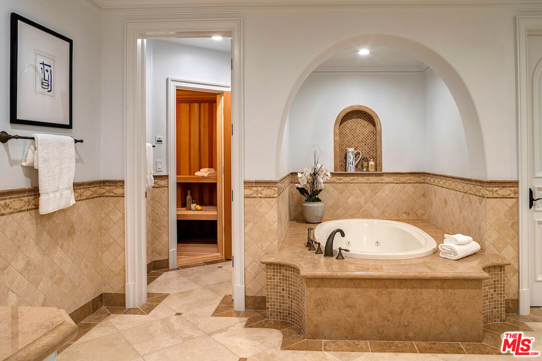 11025 Anzio Road Los Angeles, CA 90077 - Photo 30 of 34 a bathroom with a tub sink and mirror