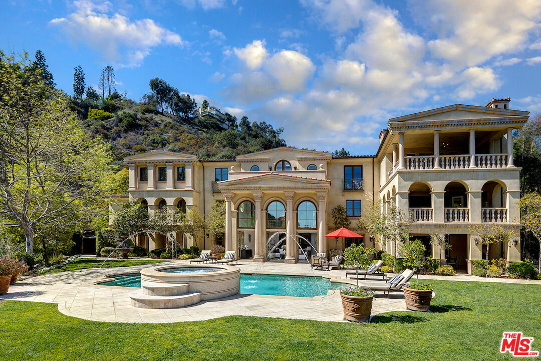 11025 Anzio Road Los Angeles, CA 90077 - Photo 32 of 34 a front view of house with yard and trees in the background