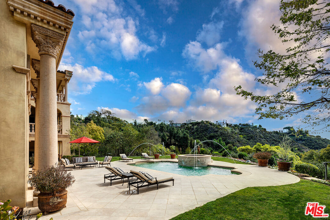 11025 Anzio Road Los Angeles, CA 90077 - Photo 33 of 34 a view of a patio with a table and chairs under an umbrella