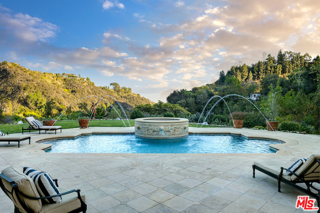 11025 Anzio Road Los Angeles, CA 90077 - Photo 34 of 34 a view of a swimming pool and lounge chair
