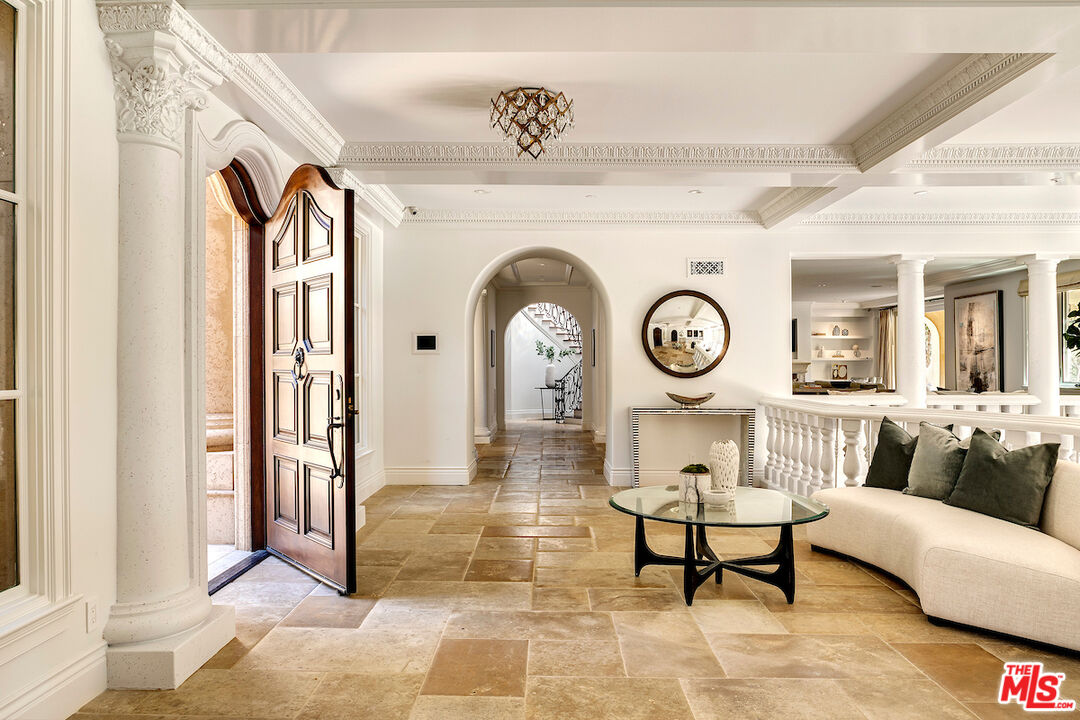 11025 Anzio Road Los Angeles, CA 90077 - Photo 8 of 34 a living room with furniture and a clock