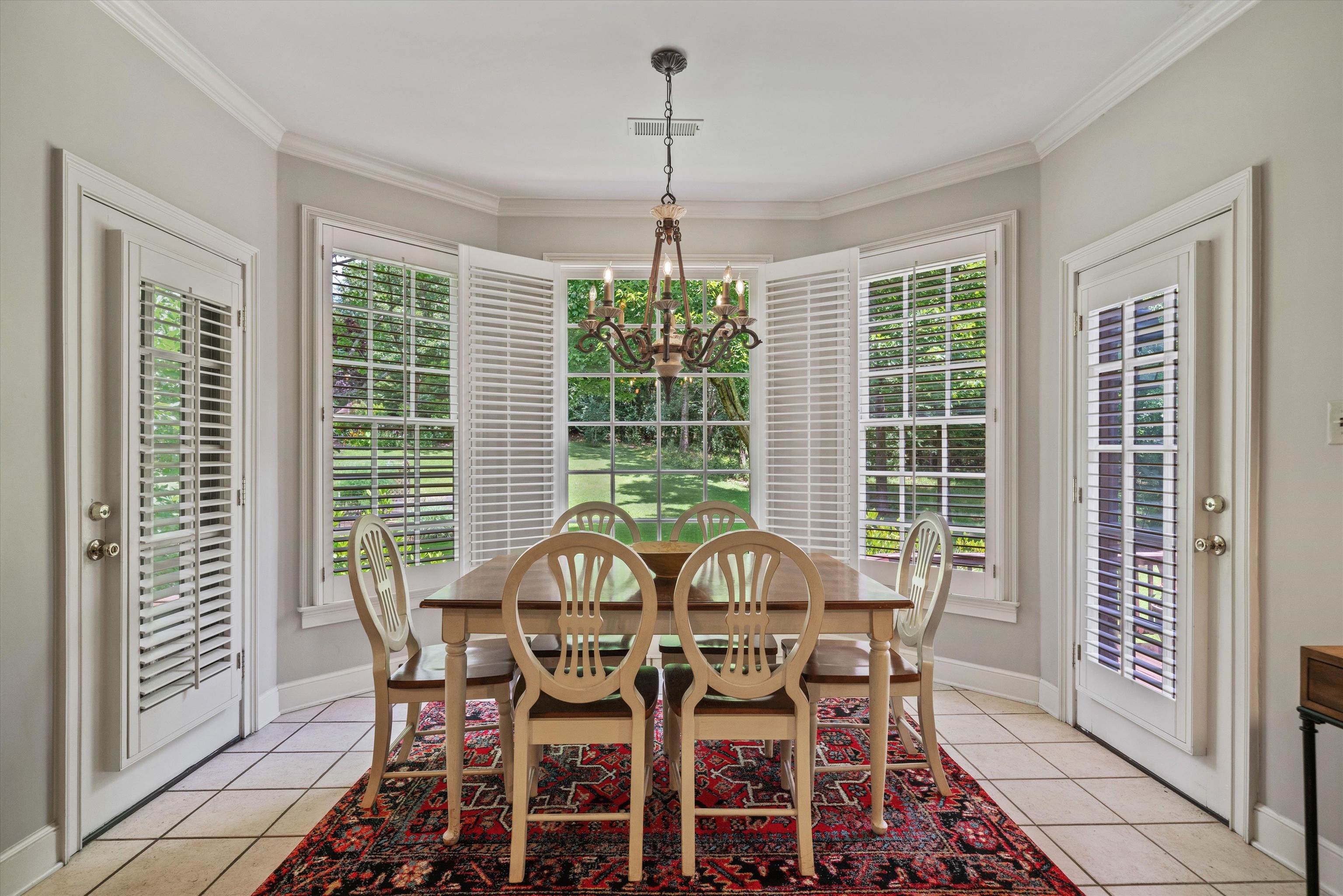 8897 Forest Ridge Cove Memphis, TN 38018 - Photo 12 of 35 Dining area with a chandelier, plenty of natural light, light tile patterned flooring, and ornamental molding