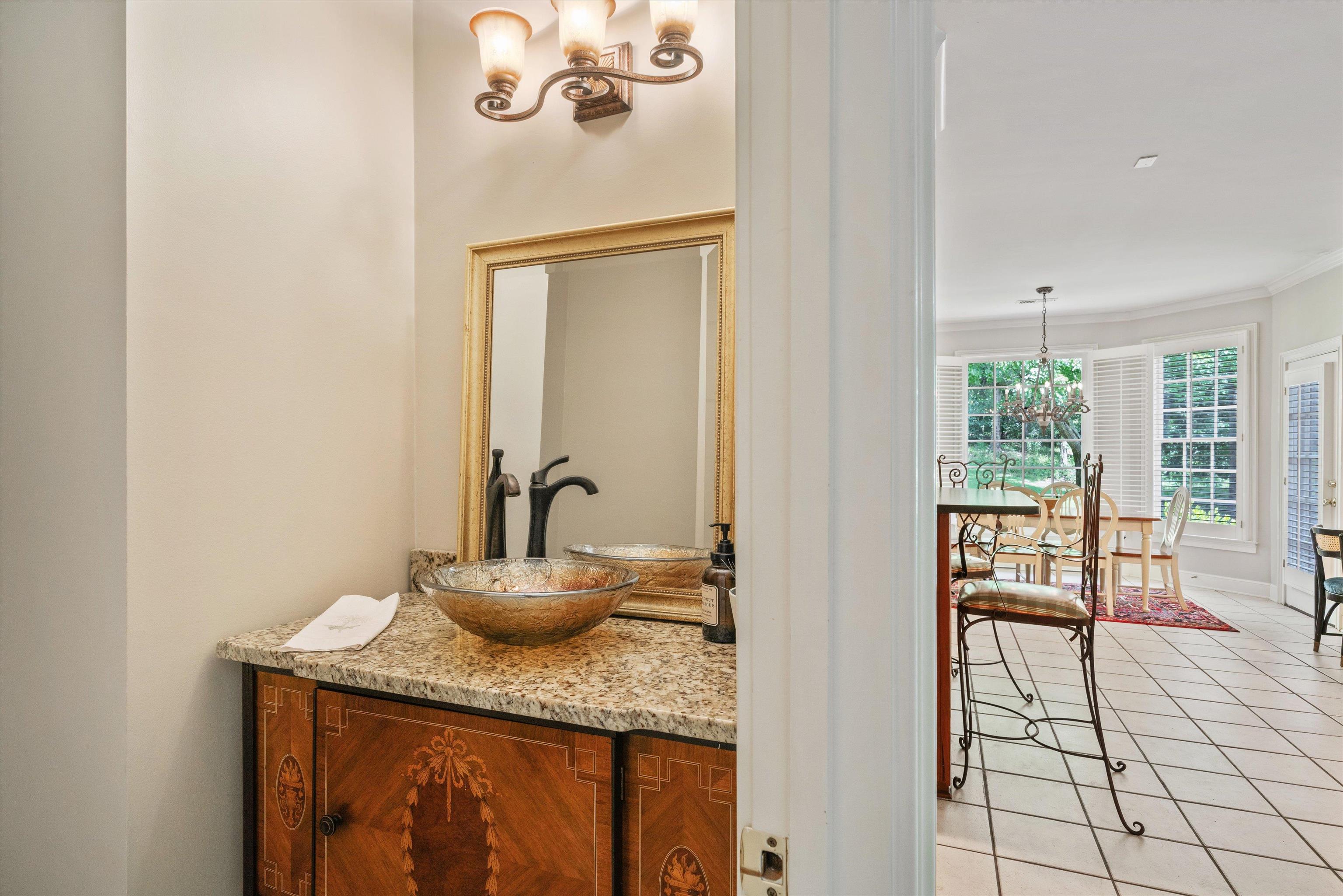 8897 Forest Ridge Cove Memphis, TN 38018 - Photo 13 of 35 Bathroom featuring a chandelier, vanity, tile patterned floors, and crown molding
