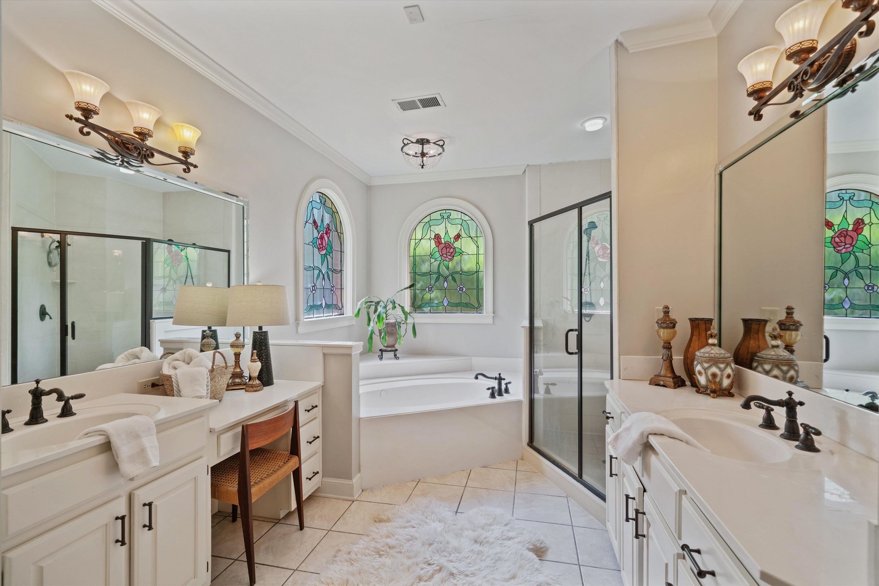 8897 Forest Ridge Cove Memphis, TN 38018 - Photo 17 of 35 Full bathroom featuring a bath, a chandelier, two vanities, a shower stall, and ornamental molding