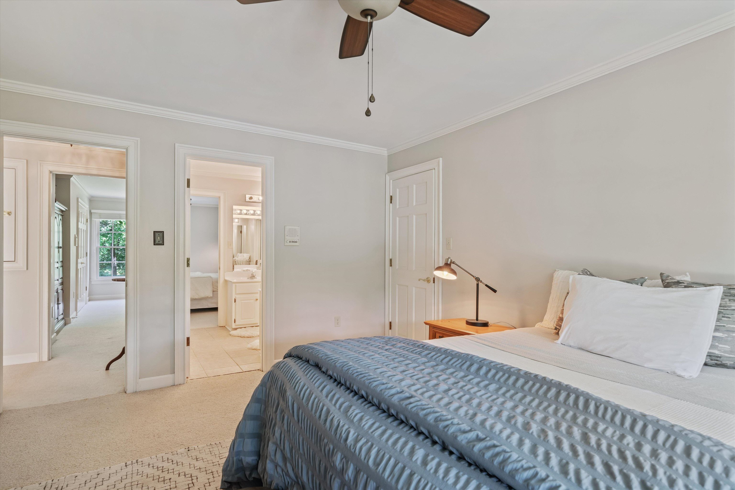 8897 Forest Ridge Cove Memphis, TN 38018 - Photo 20 of 35 Bedroom featuring light colored carpet, crown molding, ensuite bathroom, and ceiling fan