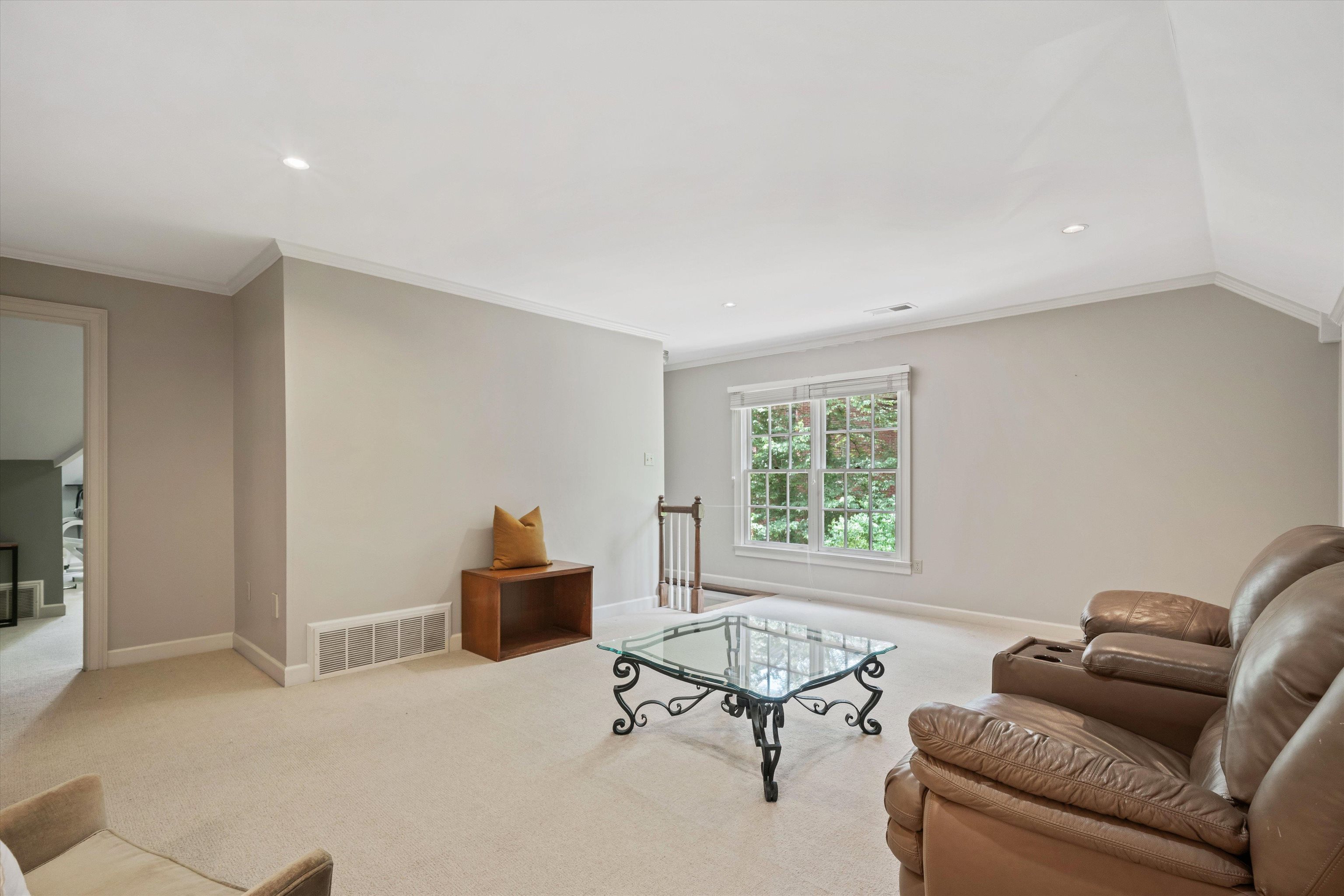 8897 Forest Ridge Cove Memphis, TN 38018 - Photo 28 of 35 Living area featuring crown molding, carpet floors, recessed lighting, and vaulted ceiling