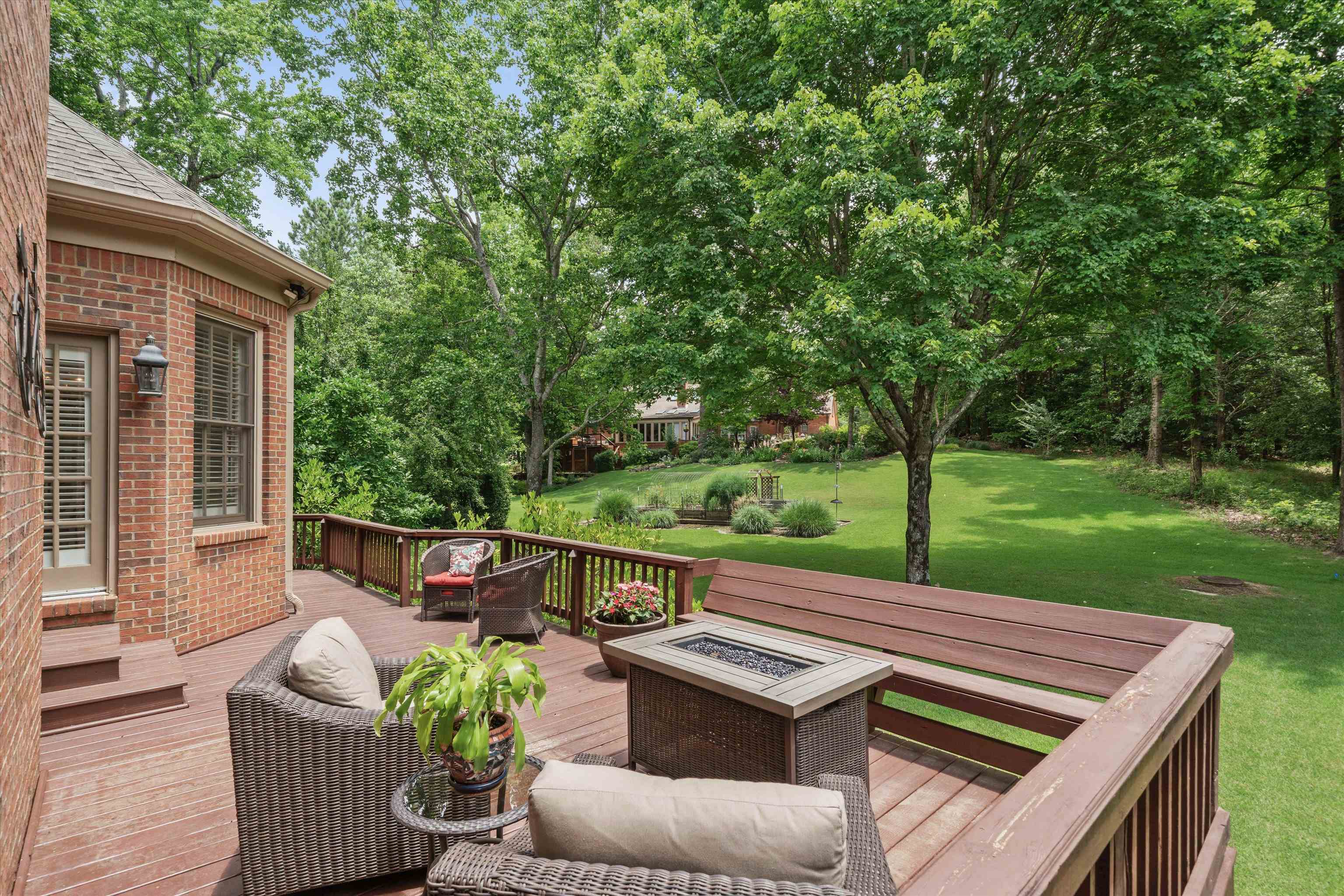 8897 Forest Ridge Cove Memphis, TN 38018 - Photo 30 of 35 Wooden terrace featuring a yard, a fire pit, and view of scattered trees