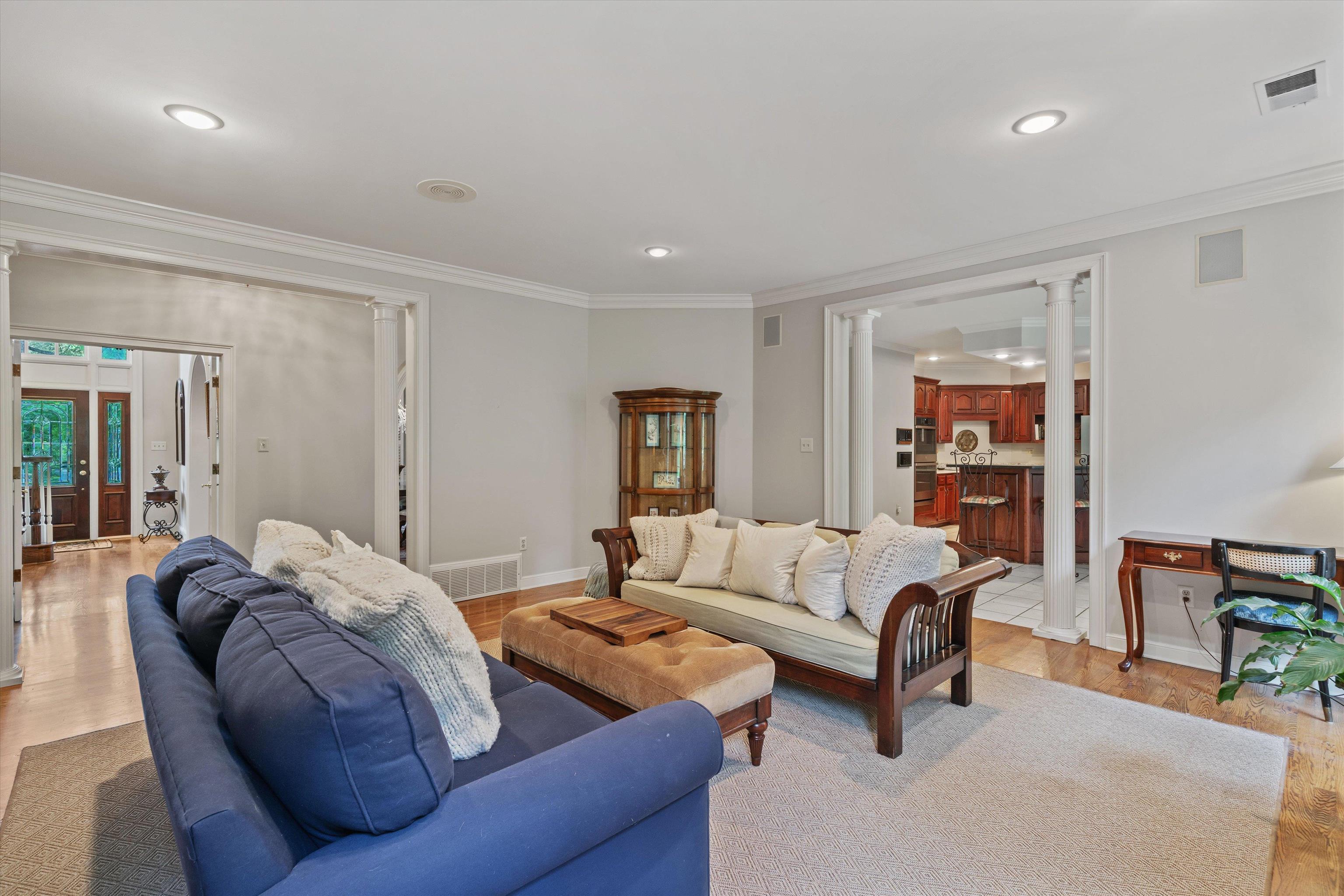 8897 Forest Ridge Cove Memphis, TN 38018 - Photo 8 of 35 Living room featuring decorative columns, ornamental molding, light wood-style flooring, recessed lighting, and french doors