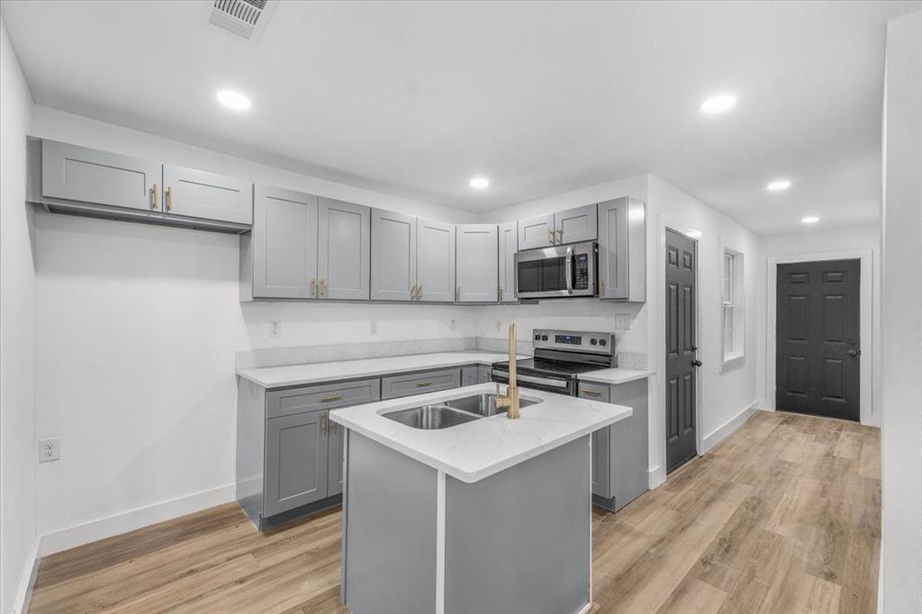 3301 Hedrick Street Fort Worth, TX 76111 - Photo 15 of 28 a kitchen with a sink stainless steel appliances and cabinets