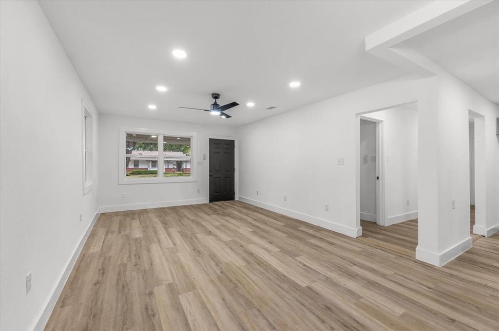 3301 Hedrick Street Fort Worth, TX 76111 - Photo 9 of 28 an empty room with wooden floor and windows