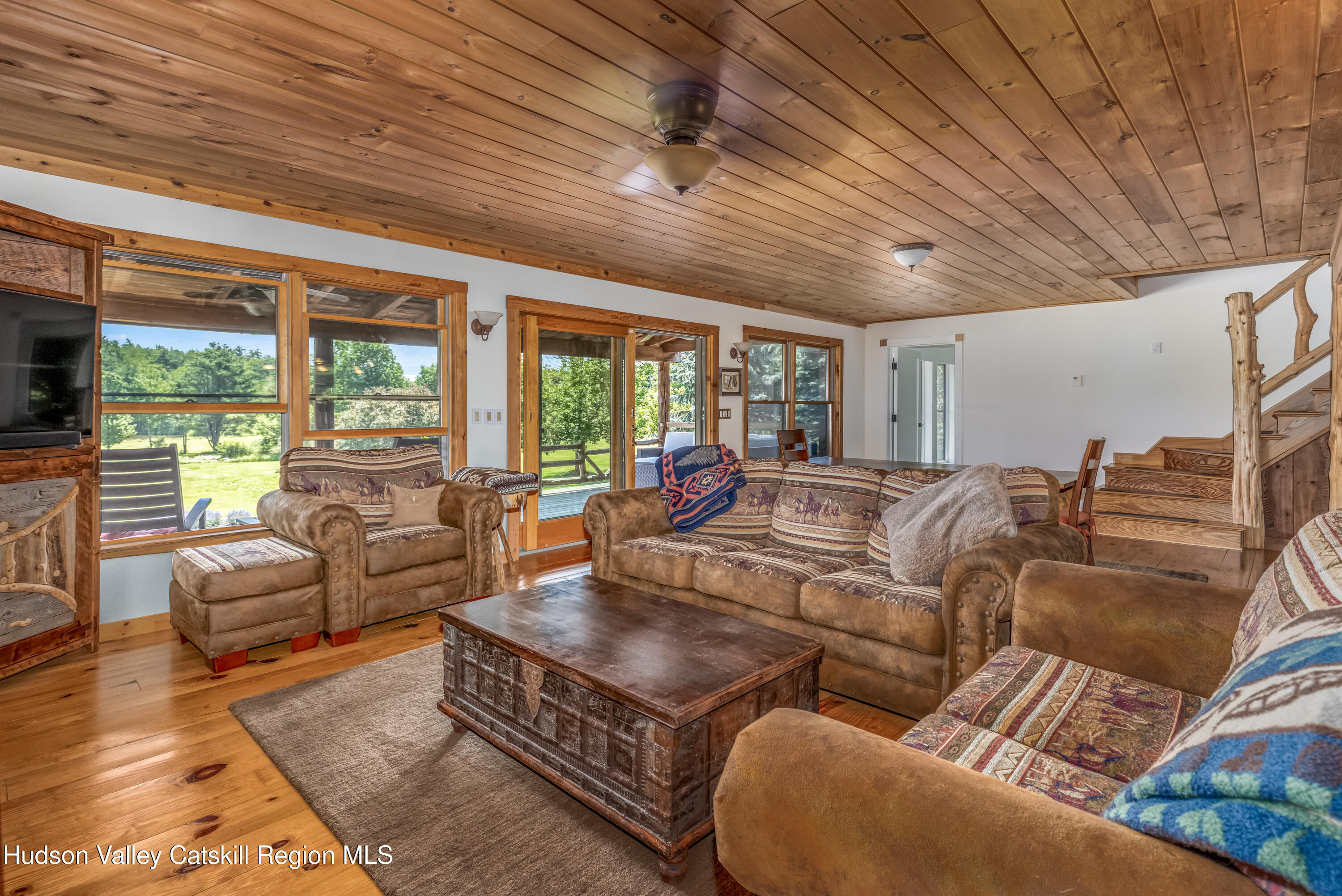 688 Bruce Porn Road Gilboa, NY 12167 - Photo 45 of 104 a living room with furniture a flat screen tv and a large window