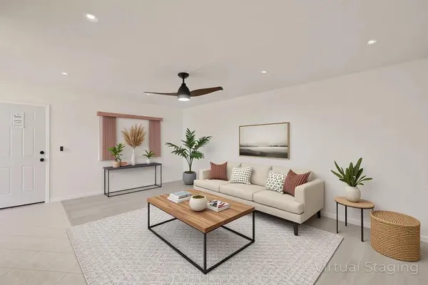 a living room with furniture and a potted plant