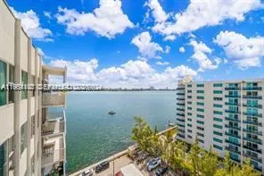 a view of a lake with tall buildings