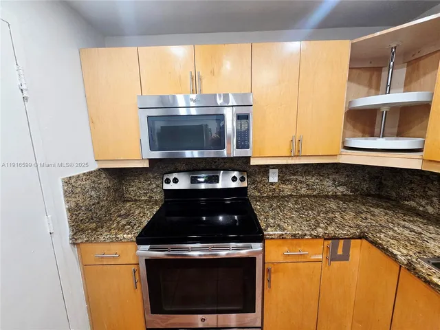 a kitchen with a stove and a microwave