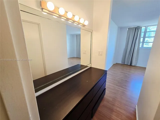 a view of a room with wooden floor