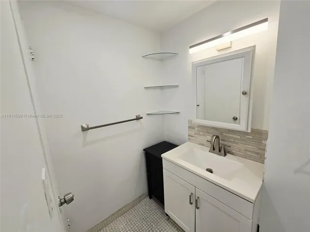 a bathroom with a sink and mirror