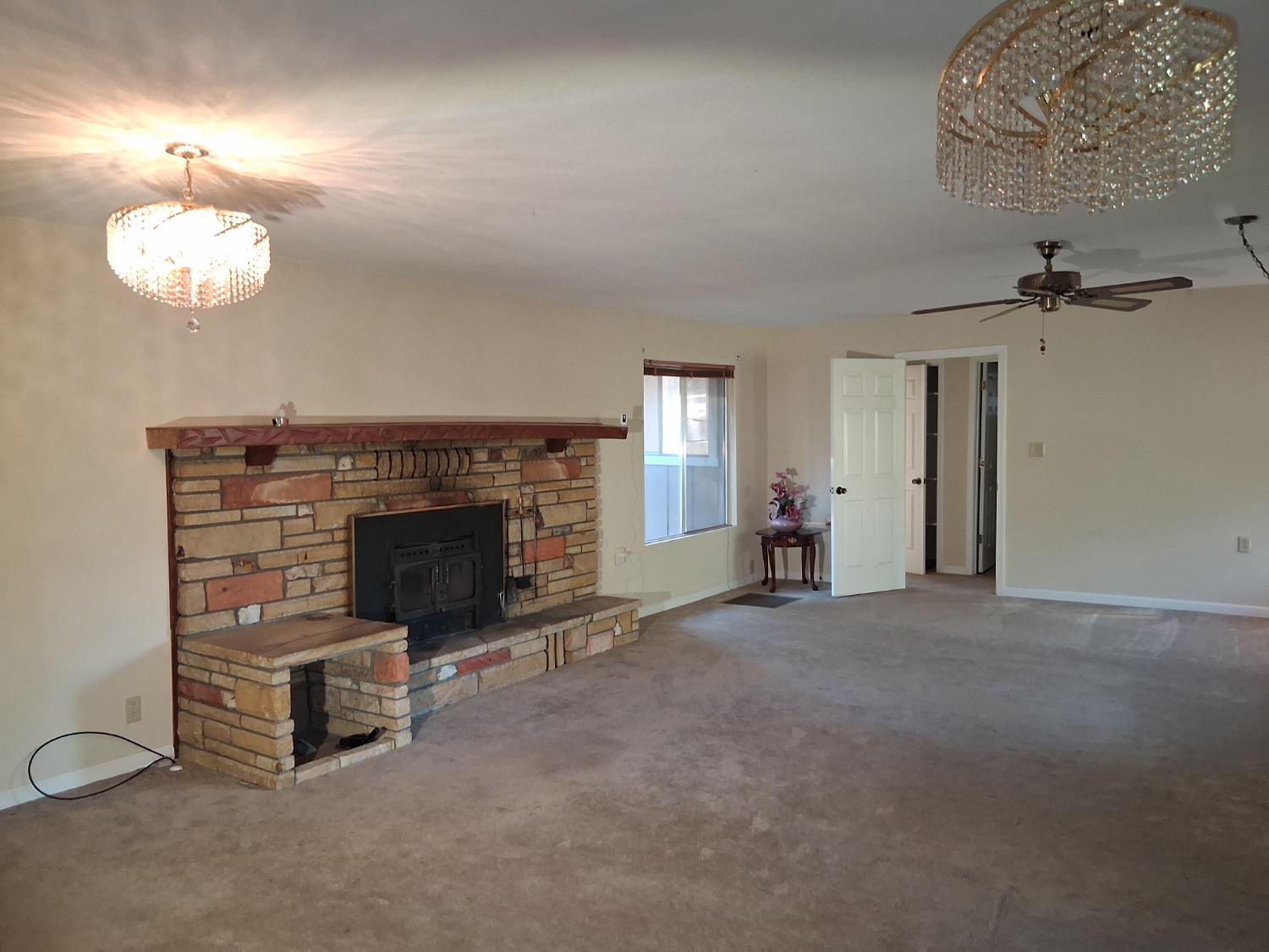 27565 Tiger Creek Road Pioneer, CA 95666 - Photo 11 of 29 an empty room with a fireplace