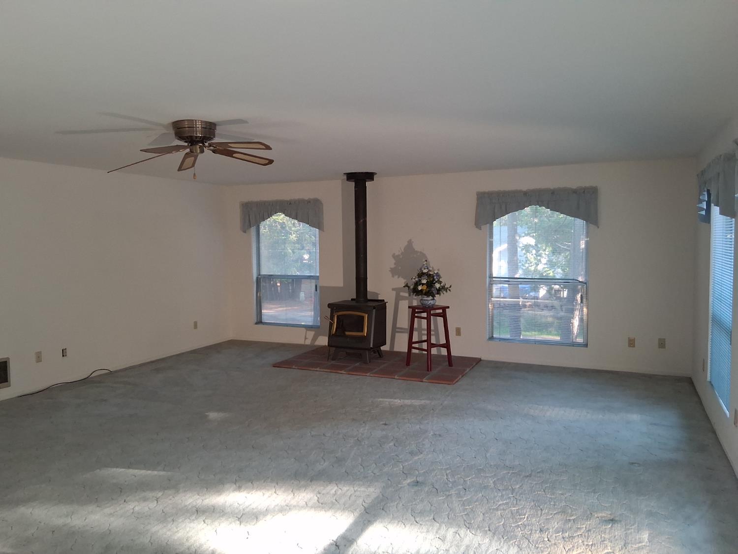 27565 Tiger Creek Road Pioneer, CA 95666 - Photo 19 of 29 an empty room with windows and fan