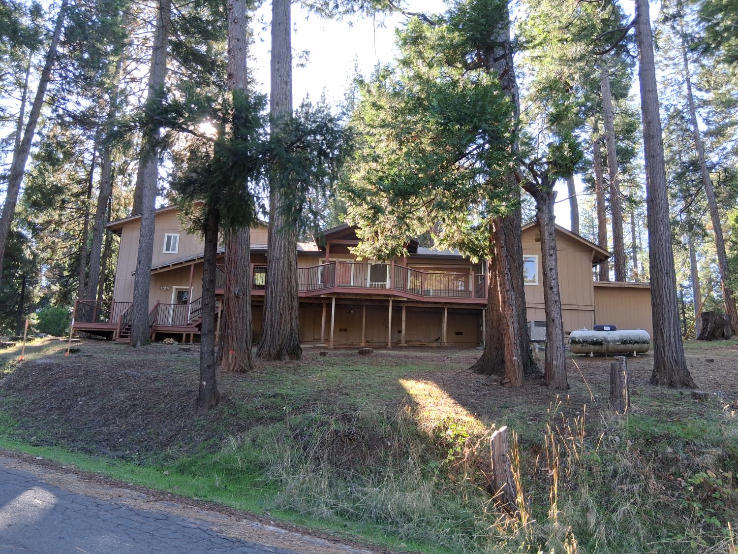 27565 Tiger Creek Road Pioneer, CA 95666 - Photo 27 of 29 a backyard of a house with table and chairs
