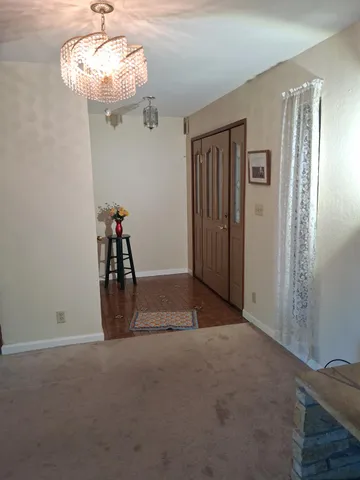 a view of a livingroom with a ceiling fan and window