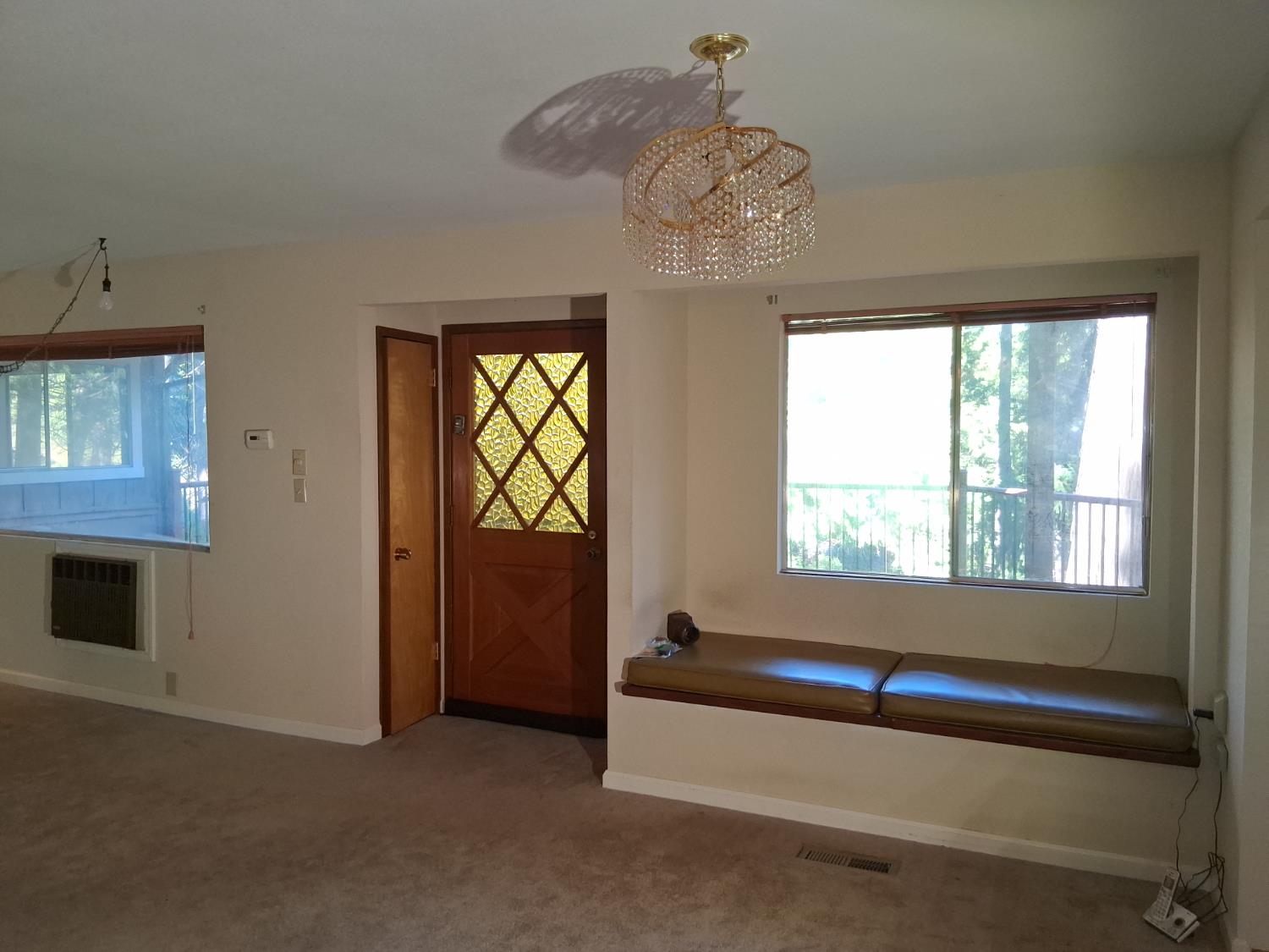 27565 Tiger Creek Road Pioneer, CA 95666 - Photo 10 of 29 a living room with furniture and a chandelier