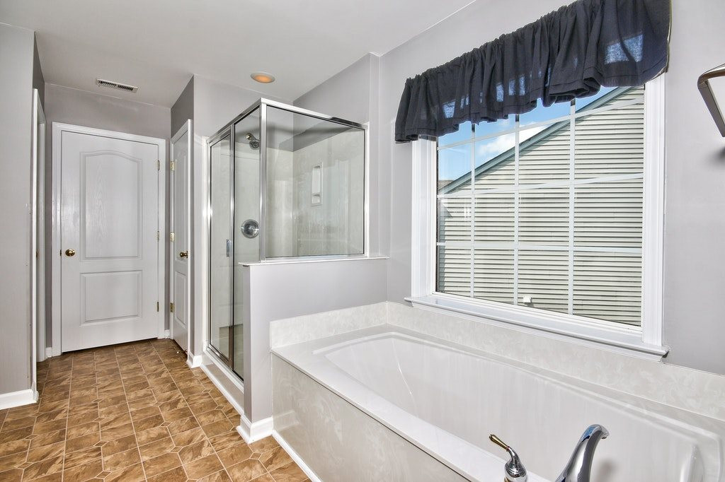 7624 Derek Drive Raleigh, NC 27613 - Photo 18 of 25 Soak in your luxurious garden tub after a day of work or play. Master Bathroom