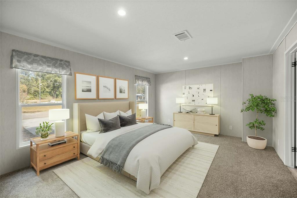 1560 Northeast 162nd Street Citra, FL 32113 - Photo 12 of 33 a bedroom with a large bed and a couch