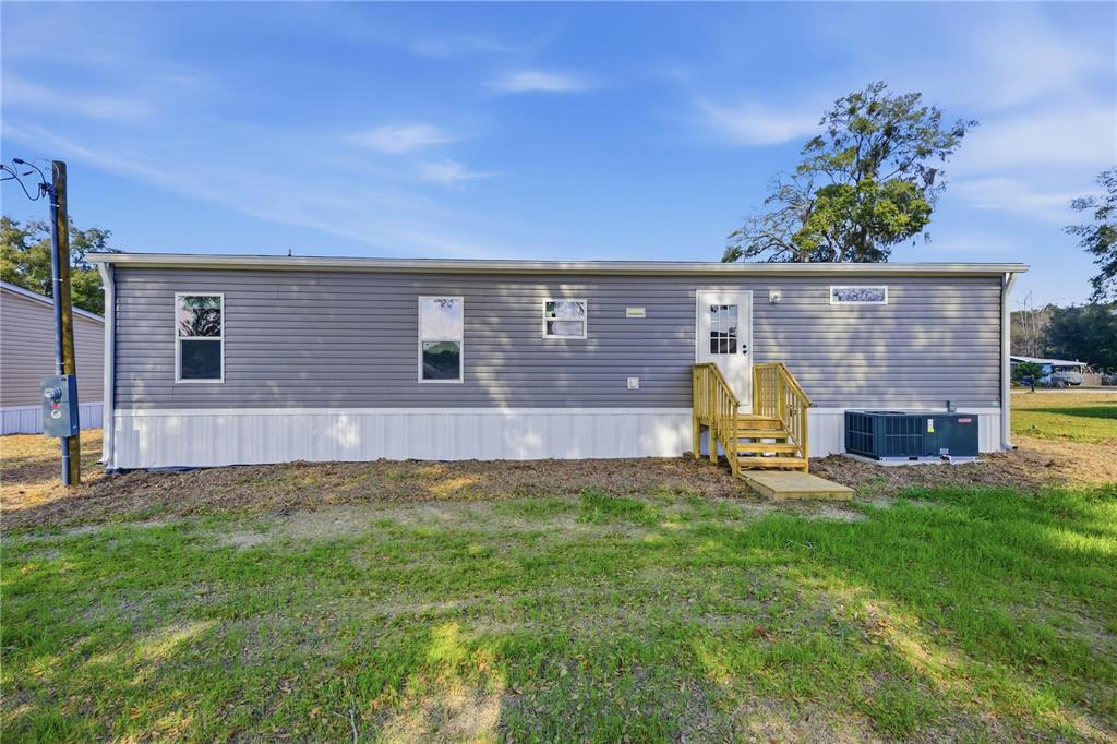1560 Northeast 162nd Street Citra, FL 32113 - Photo 26 of 33 a view of a backyard with table and chair and potted plants