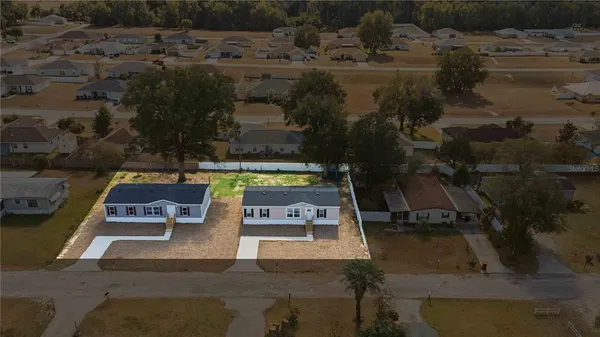 an aerial view of a house with outdoor space