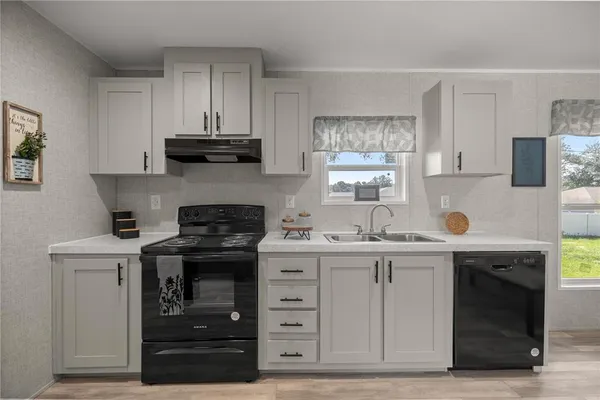 a kitchen with stainless steel appliances granite countertop a stove and cabinets