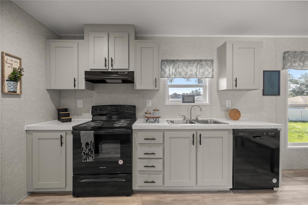 1560 Northeast 162nd Street Citra, FL 32113 - Photo 10 of 33 a kitchen with stainless steel appliances granite countertop a stove and cabinets