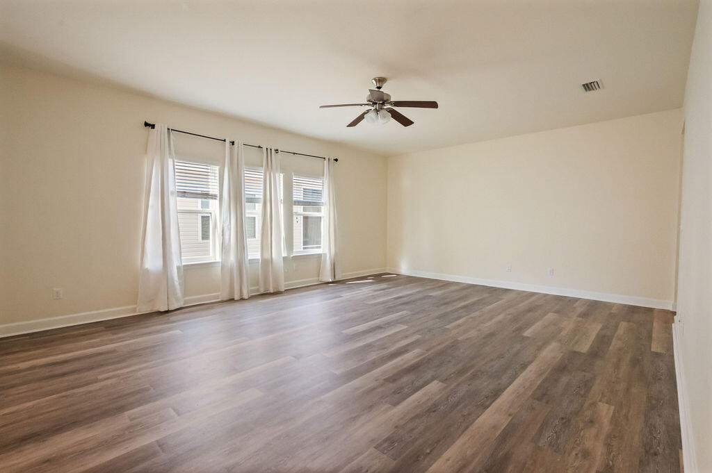 108 Nelly Street Freeport, FL 32439 - Photo 11 of 59 a view of empty room with wooden floor and fan