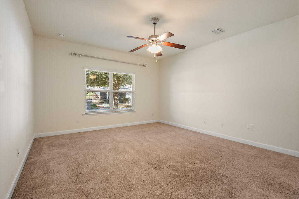 108 Nelly Street Freeport, FL 32439 - Photo 13 of 59 an empty room with windows and fan