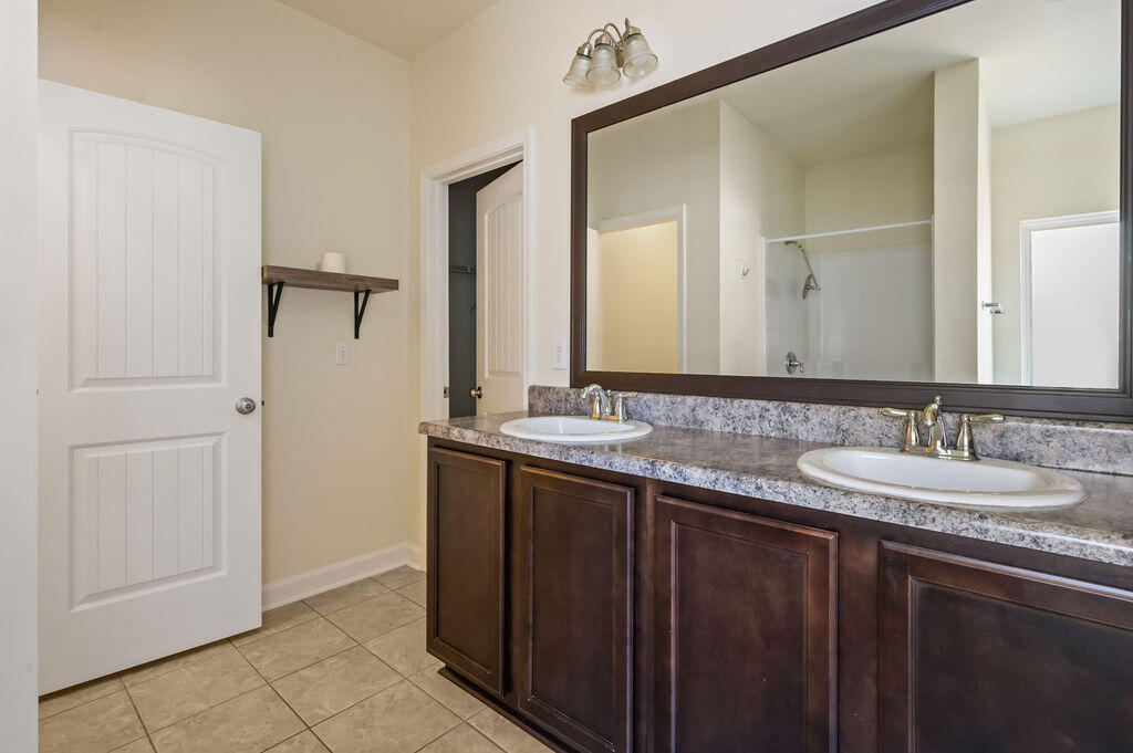 108 Nelly Street Freeport, FL 32439 - Photo 14 of 59 a bathroom with a double vanity sink and a mirror