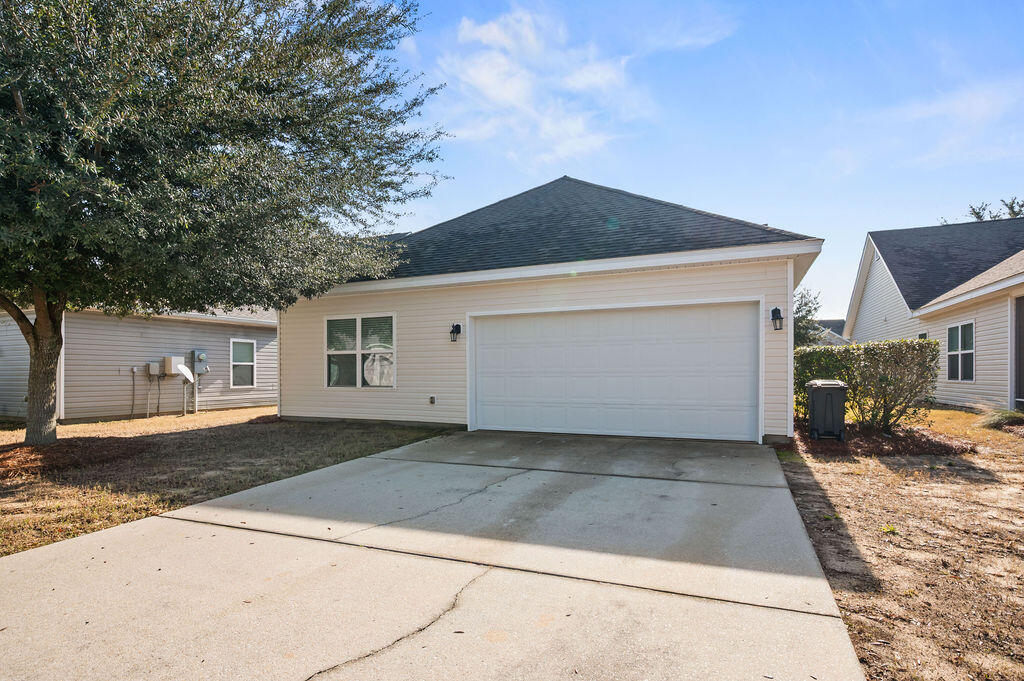 108 Nelly Street Freeport, FL 32439 - Photo 3 of 59 a front view of a house with a yard
