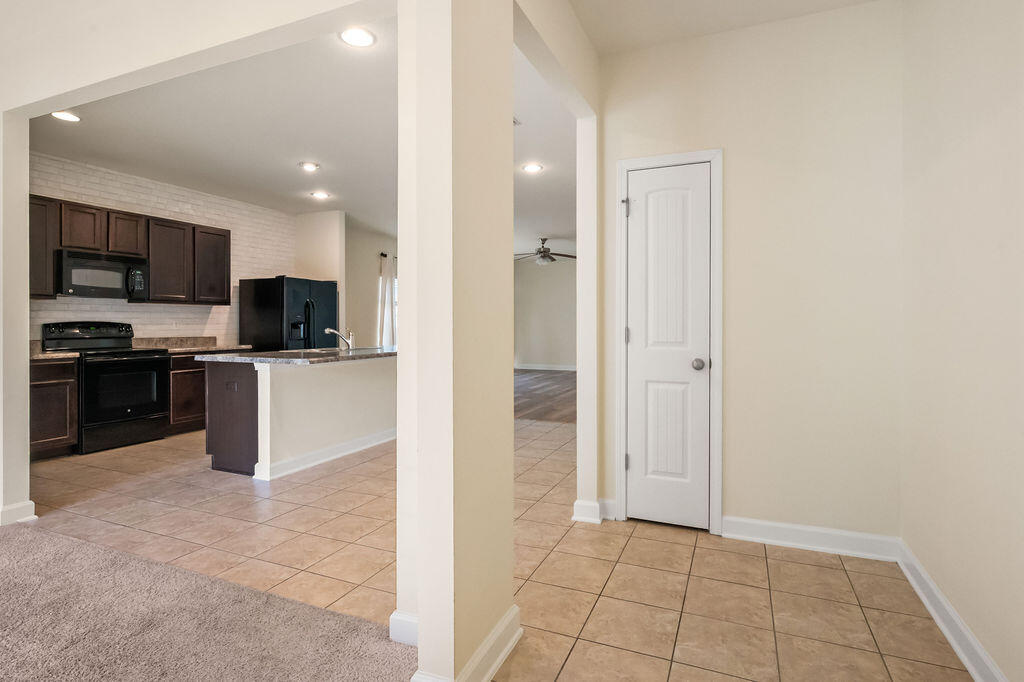 108 Nelly Street Freeport, FL 32439 - Photo 5 of 59 a large kitchen with cabinets and stainless steel appliances