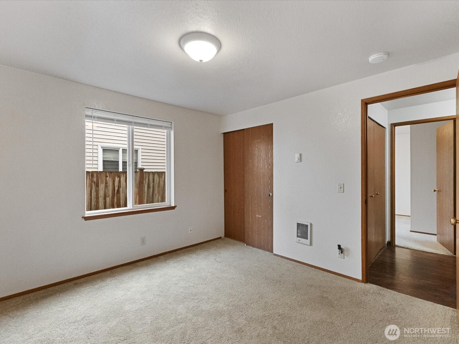 13411 Meadow Road Everett, WA 98208 - Photo 16 of 40 an empty room with a window and a kitchen