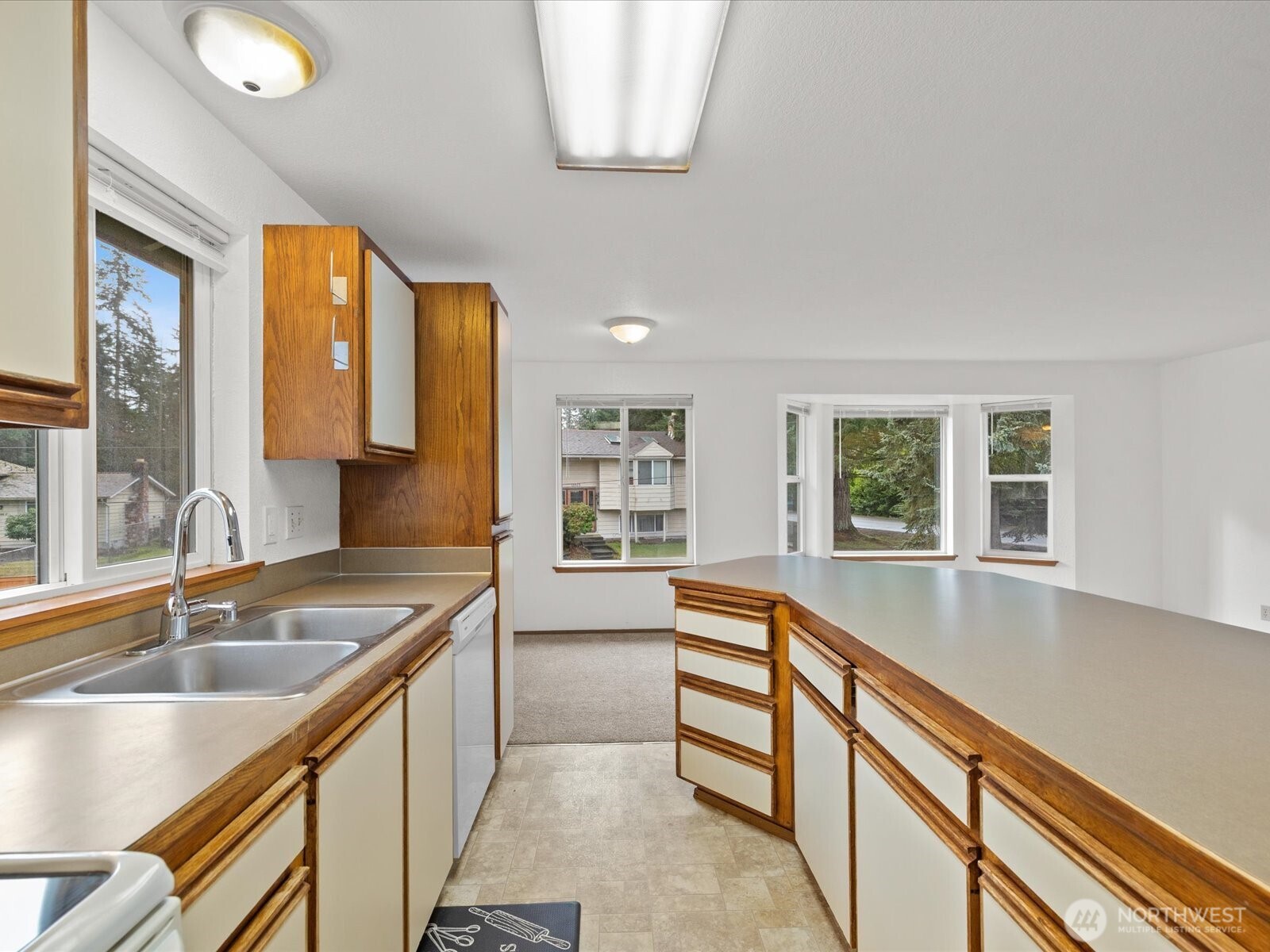 13411 Meadow Road Everett, WA 98208 - Photo 22 of 40 a kitchen with stainless steel appliances granite countertop a sink and a oven
