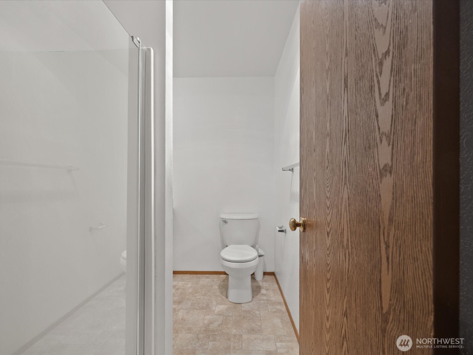 13411 Meadow Road Everett, WA 98208 - Photo 24 of 40 a white toilet sitting next to a shower curtain