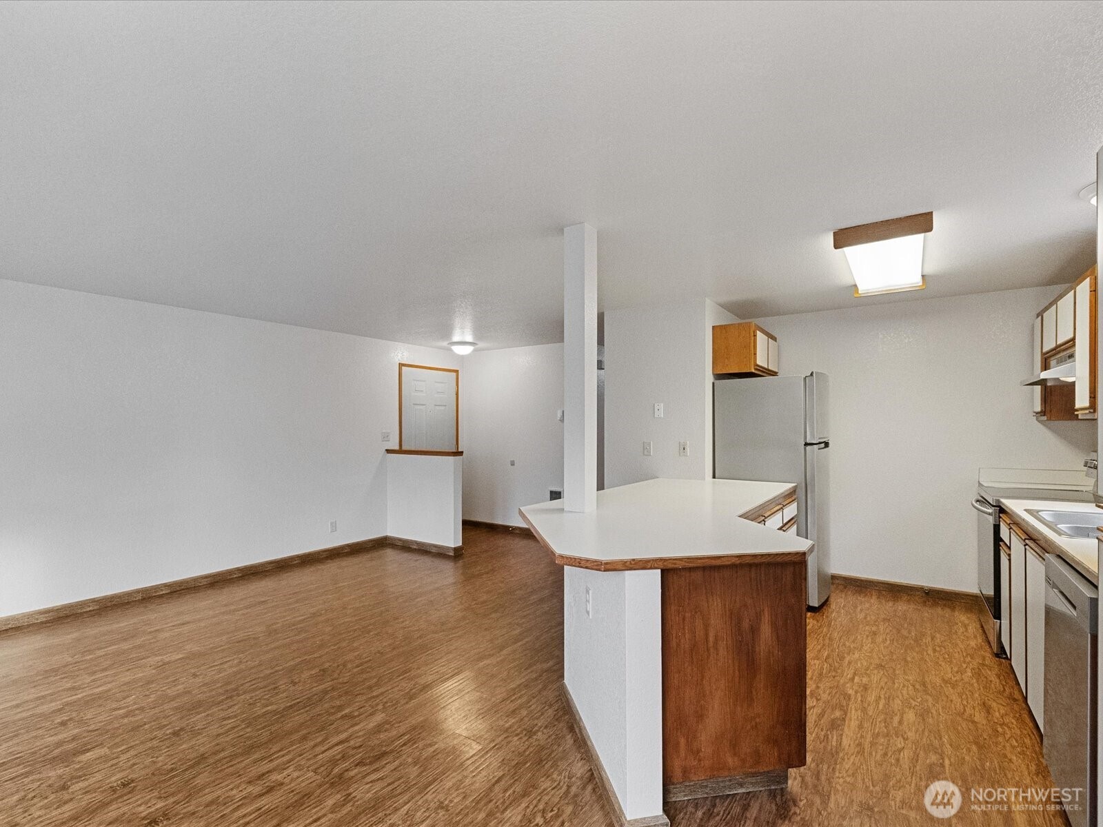 13411 Meadow Road Everett, WA 98208 - Photo 29 of 40 a view of a kitchen with wooden floor and a sink