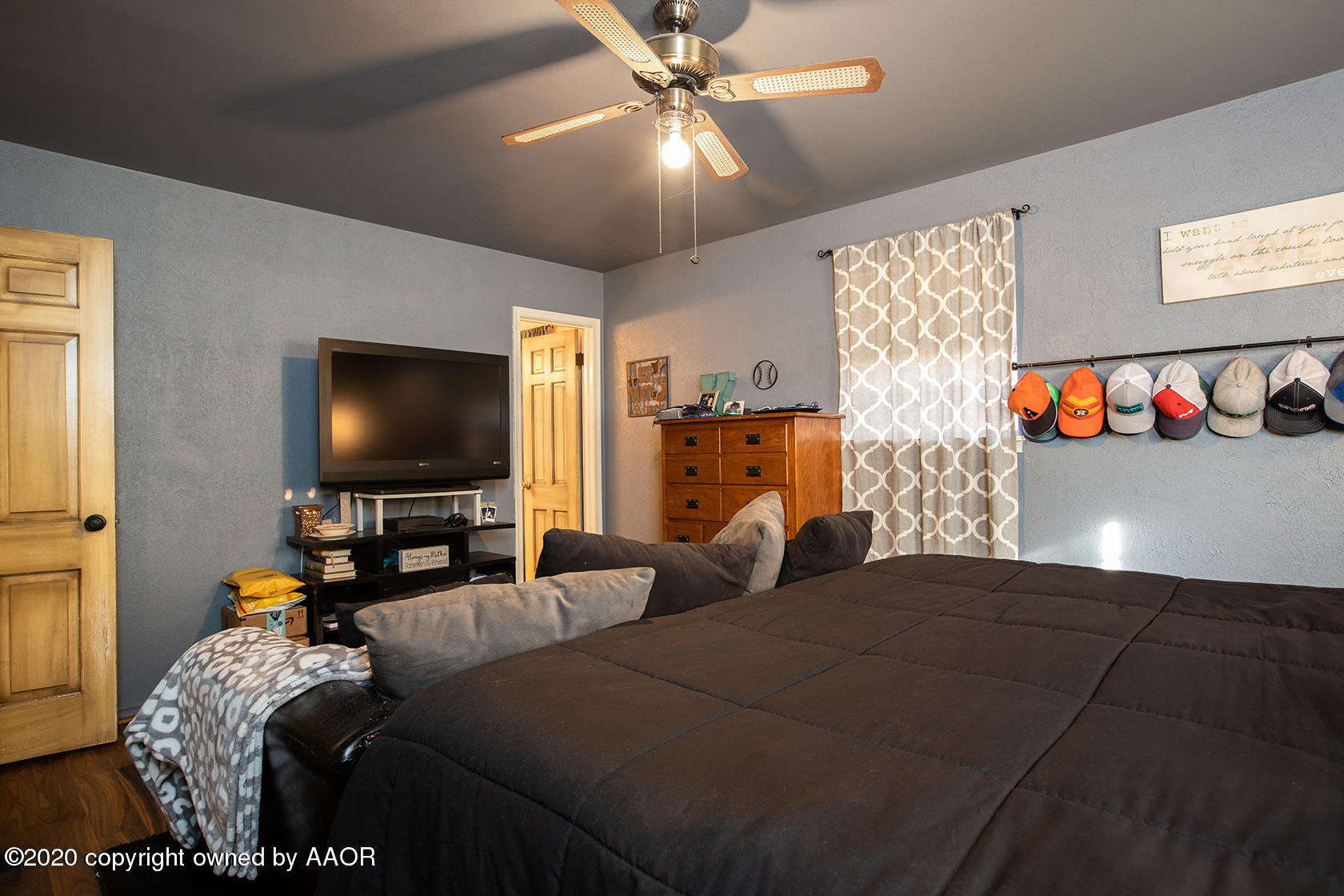 6017 Calumet Road Amarillo, TX 79106 - Photo 21 of 31 a bedroom with a bed and a flat screen tv